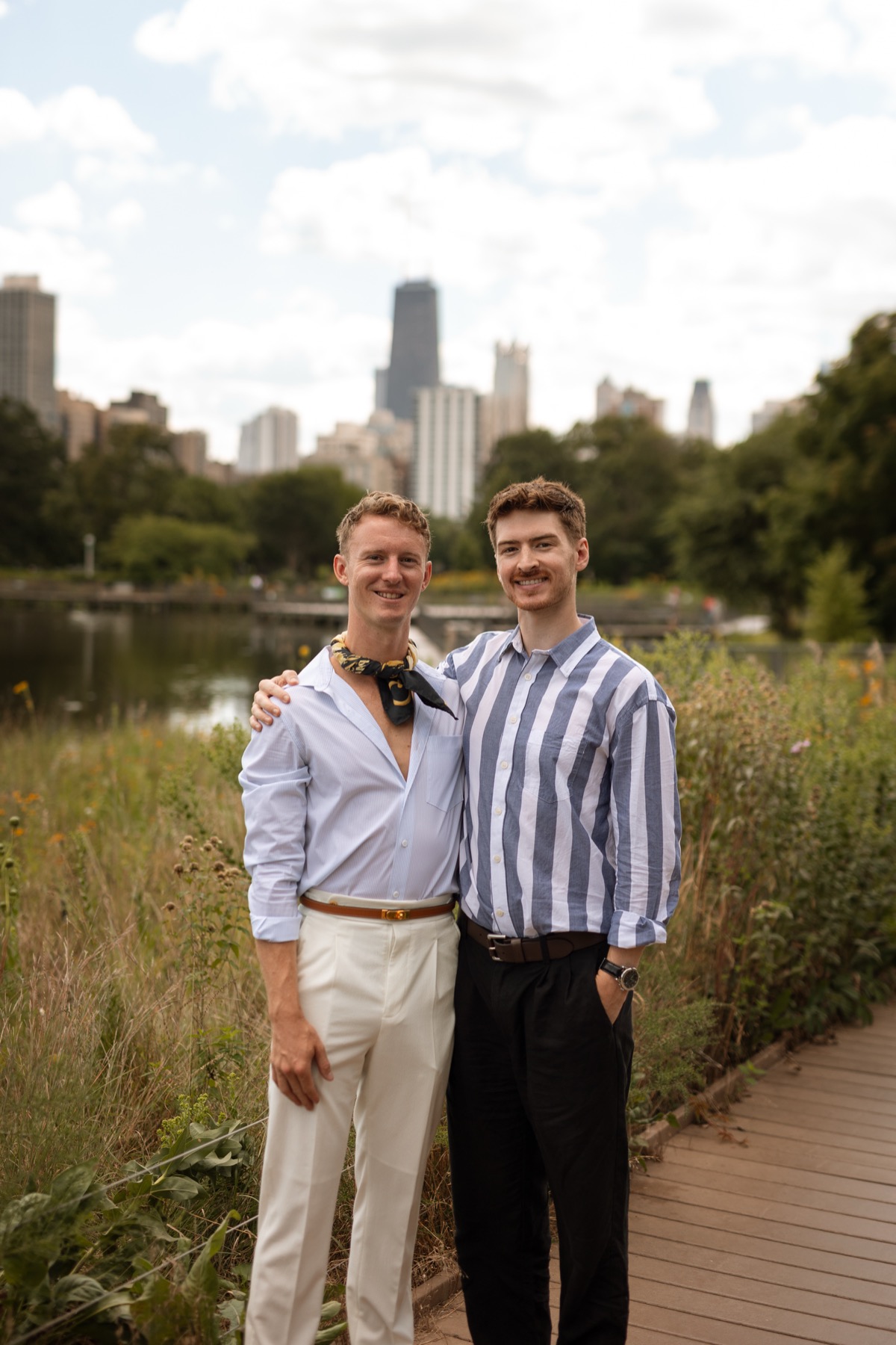 Brendan and Scott on a boardwalk with wildflowers and the Chicago skyline